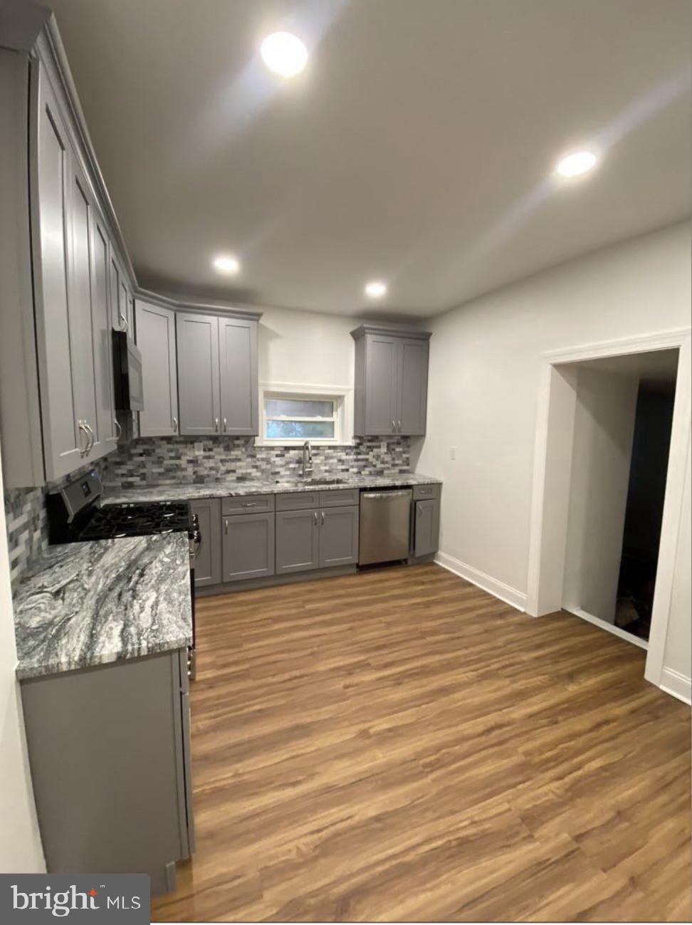 758 Fremont Street Lancaster, PA 17603 - Photo 5 of 20 a large kitchen with stainless steel appliances granite countertop a stove a sink and a refrigerator