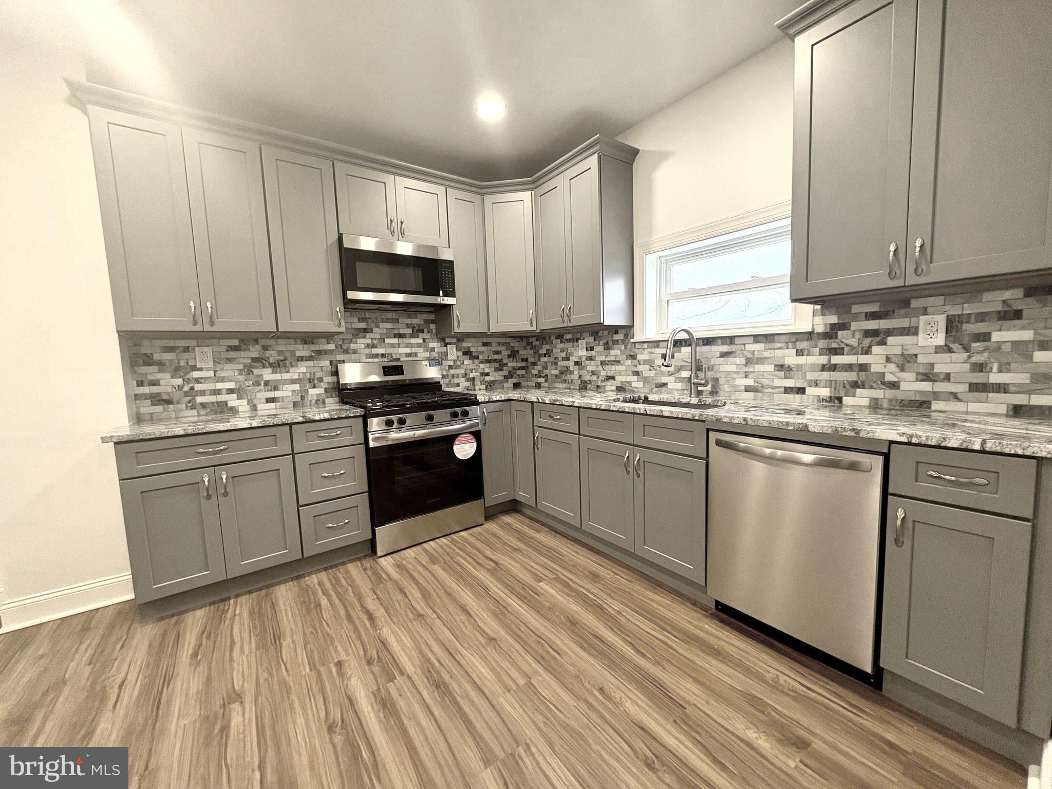 758 Fremont Street Lancaster, PA 17603 - Photo 7 of 20 a kitchen with stainless steel appliances granite countertop a stove a sink dishwasher and a refrigerator