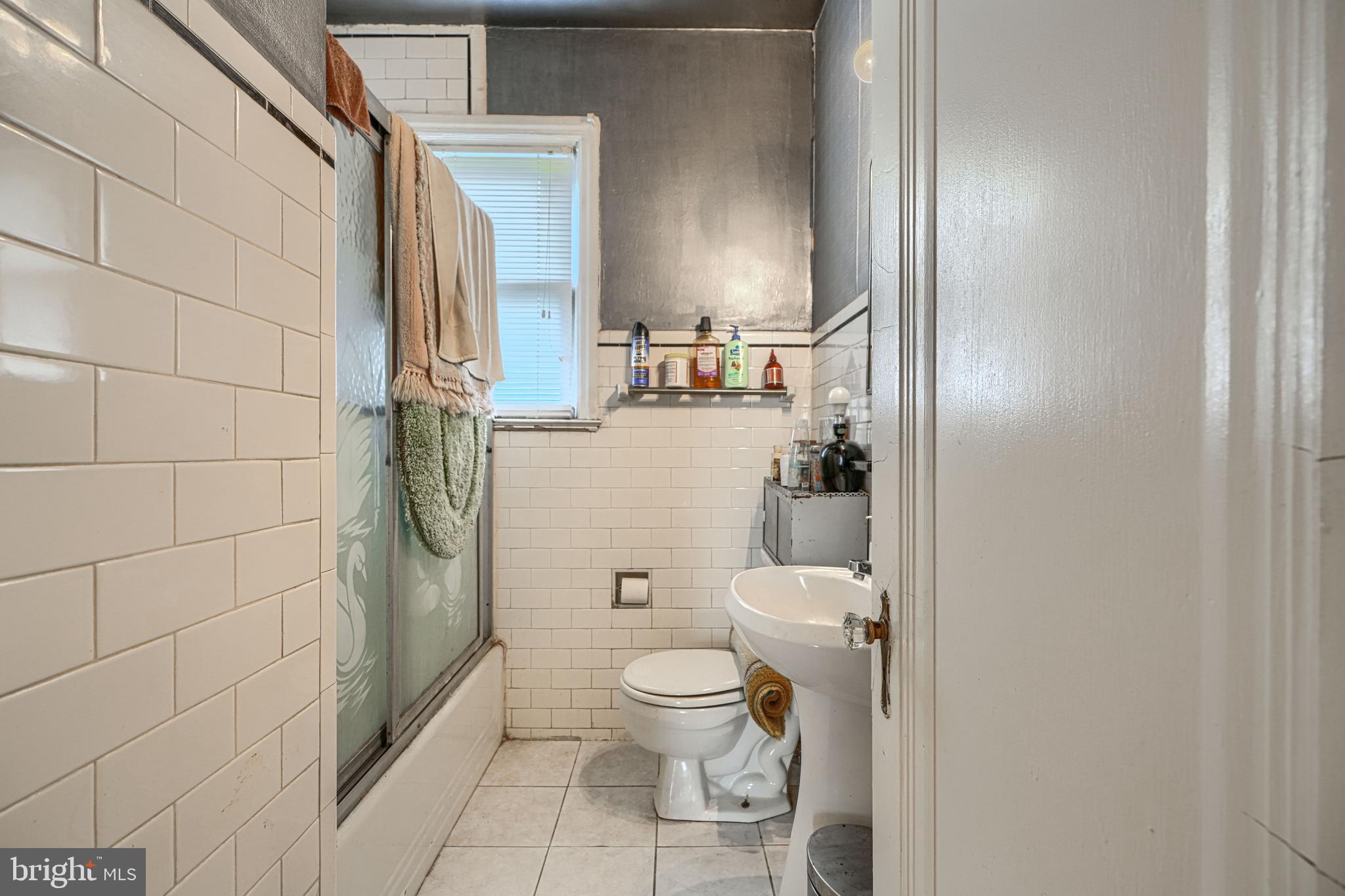3212 Dorchester Road Baltimore, MD 21215 - Photo 32 of 45 a bathroom with a toilet and a shower
