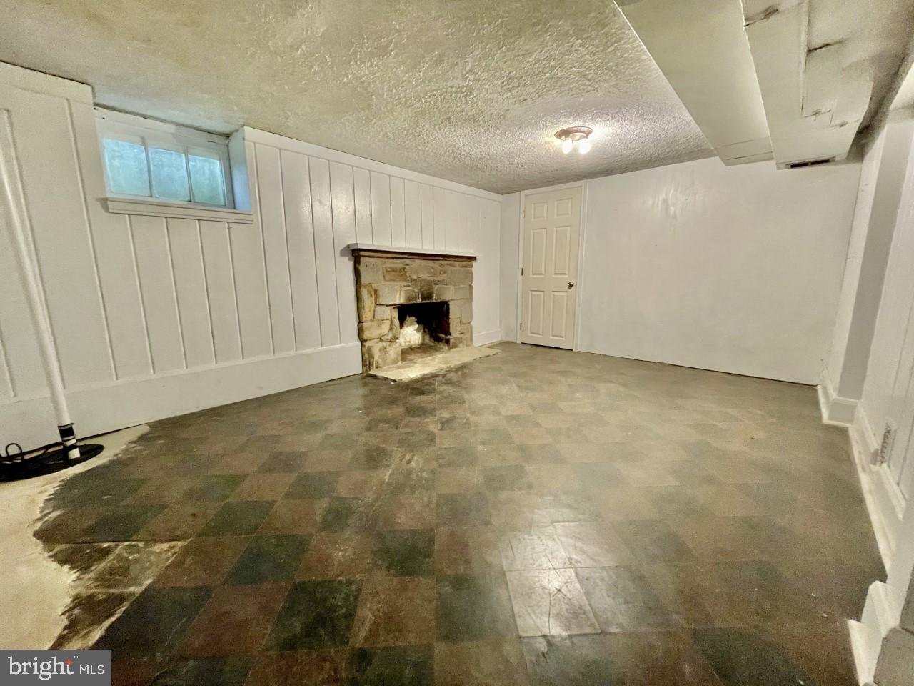 819 Tred Avon Road Baltimore, MD 21212 - Photo 18 of 25 Rec room in basement with fireplace