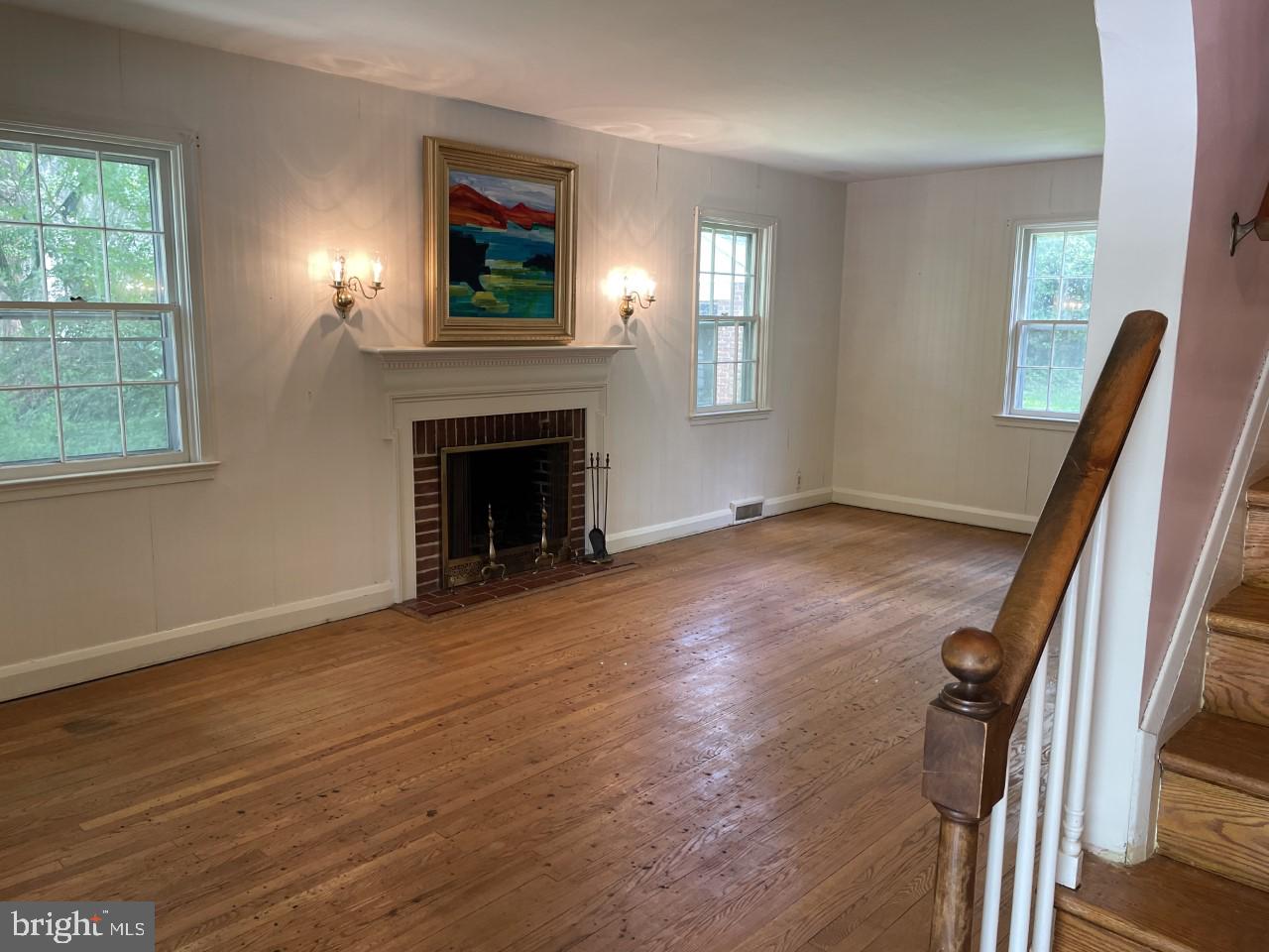 819 Tred Avon Road Baltimore, MD 21212 - Photo 4 of 25 Living room with hardwood floors and fireplace.
