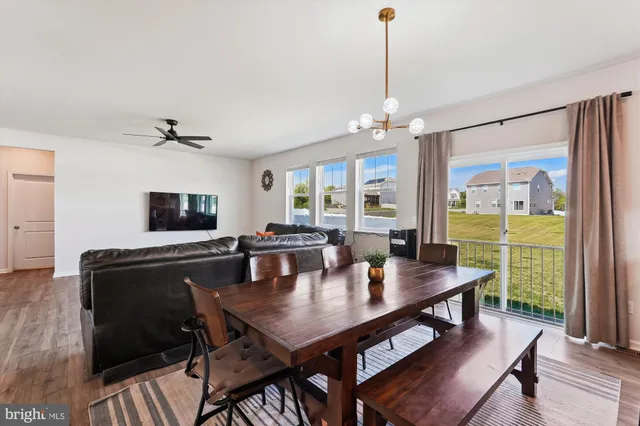 a large kitchen with granite countertop lots of counter space dining table and stainless steel appliances