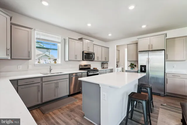 a kitchen with a stove a sink and a refrigerator