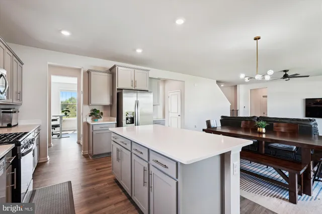 a kitchen with counter top space appliances and a center island