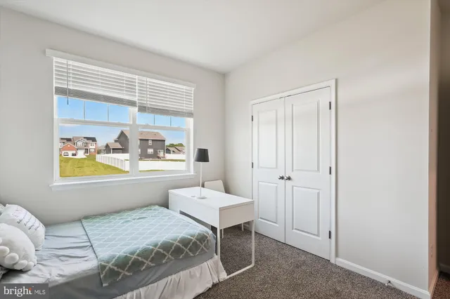 a living room with furniture a flat screen tv and a open window