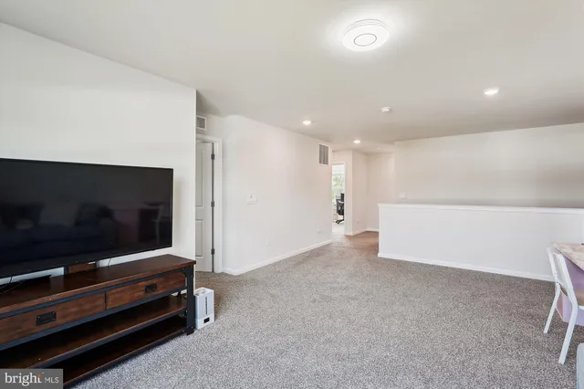 a bedroom with a bed and painting on the wall