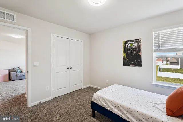 a bedroom with a bed and closet