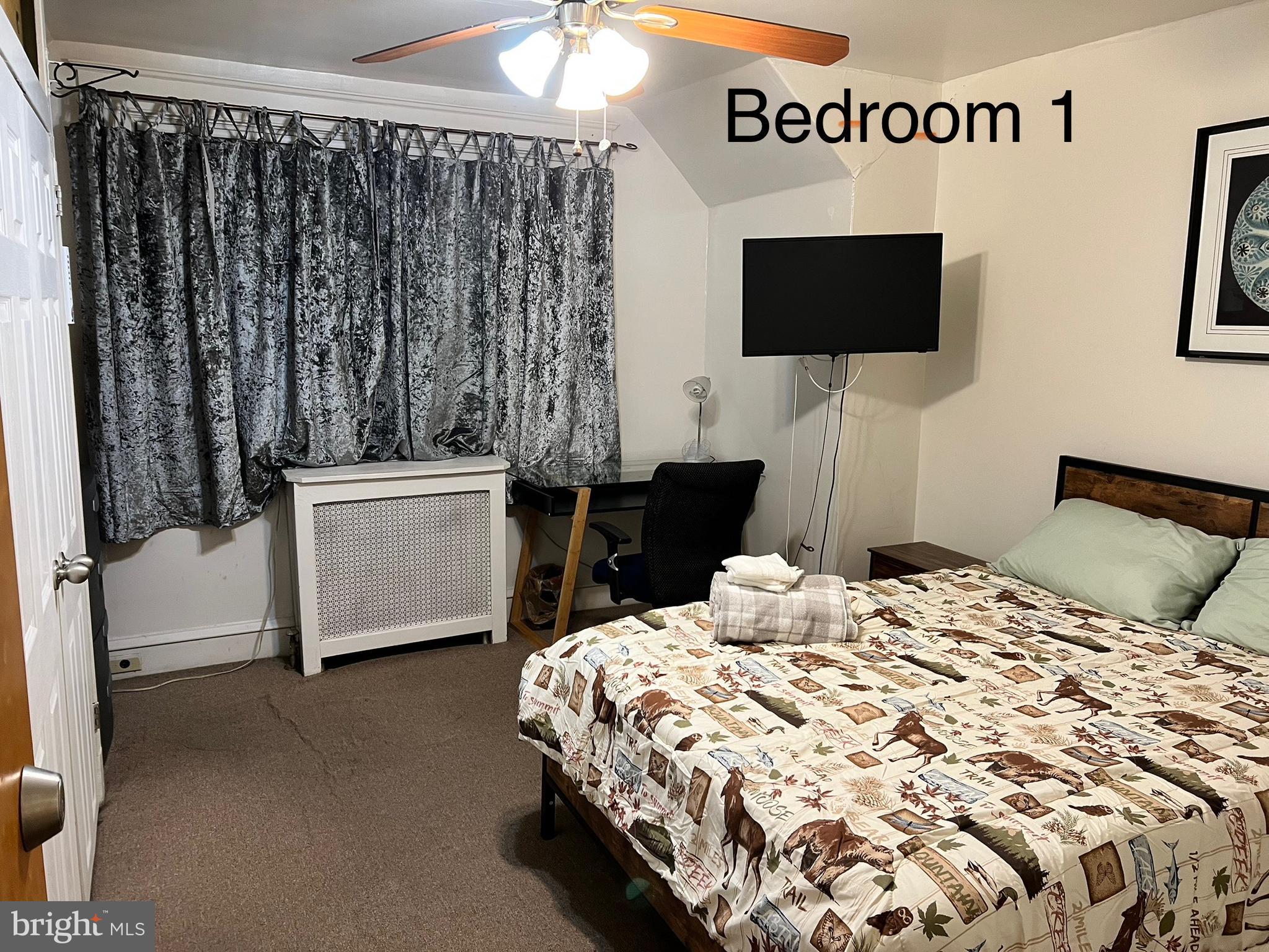 539 Timberlake Road Upper Darby, PA 19082 - Photo 8 of 17 a bedroom with a bed tv and a mirror