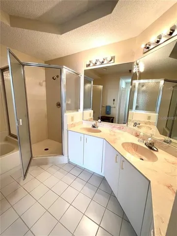 a spacious bathroom with a mirror a shower and a sink