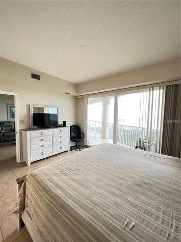 a large bedroom with a large bed and a window