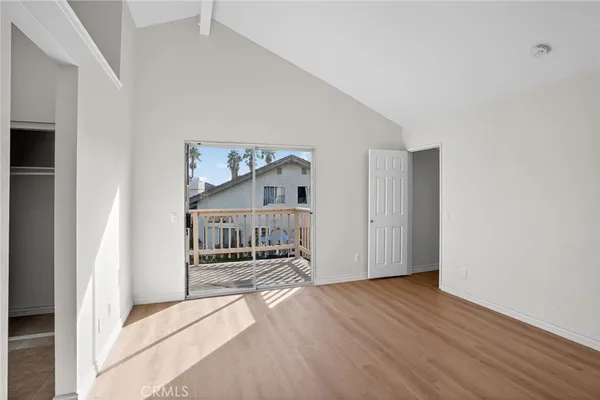 a view of a livingroom with wooden floor and furniture