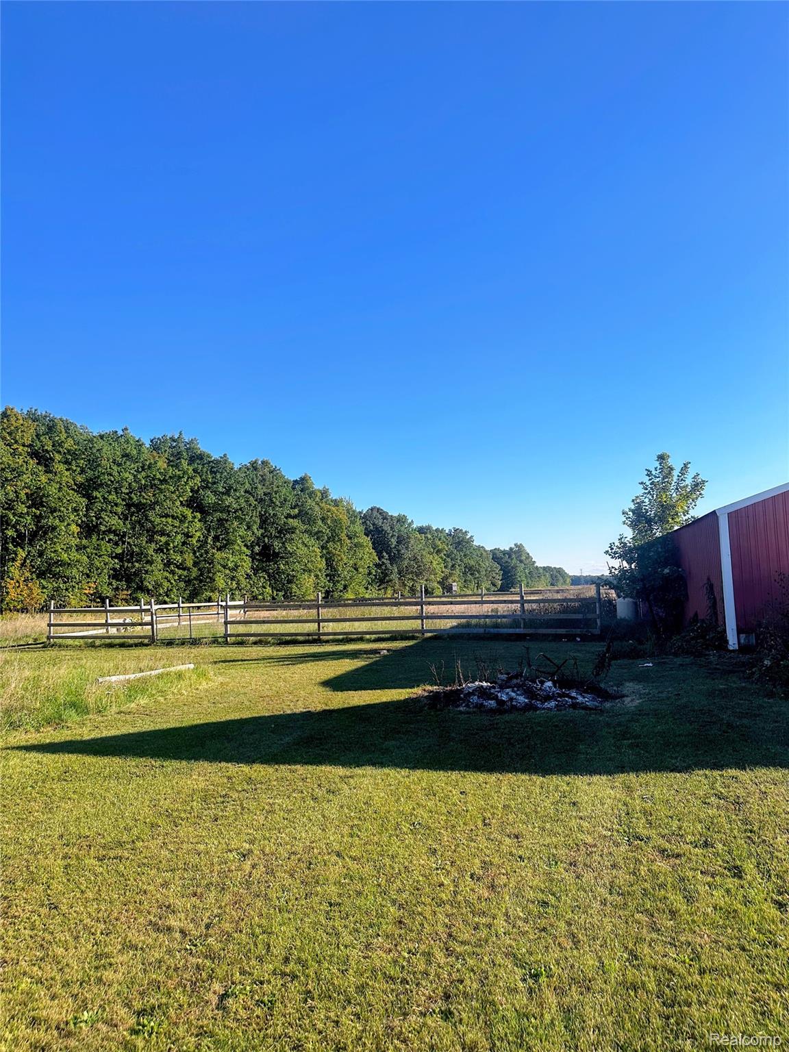 7305 West Gary Road Chesaning, MI 48616 - Photo 8 of 27 Expansive lawn area with a fenced perimeter and mature trees