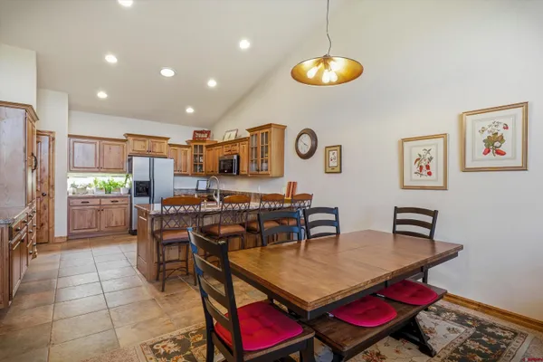 a kitchen with stainless steel appliances granite countertop a stove refrigerator and a sink