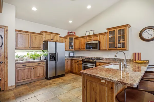 a kitchen with a sink and a stove top oven