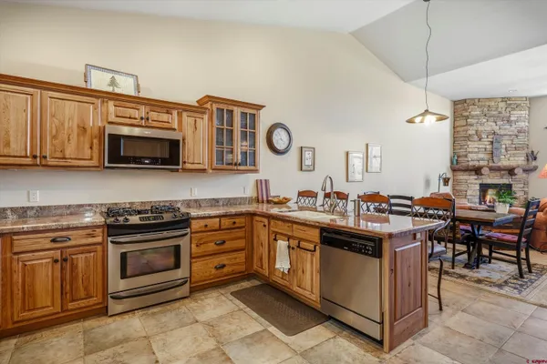 a bathroom with a granite countertop sink a mirror and a shower