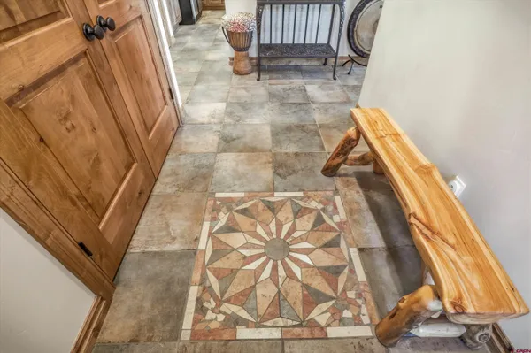 a living room with fireplace furniture and a floor to ceiling window