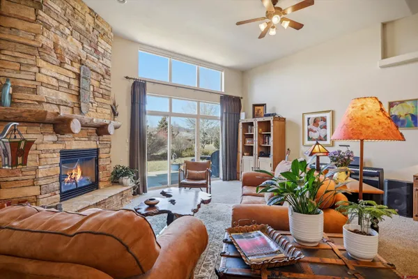 a living room with furniture a fireplace and a window