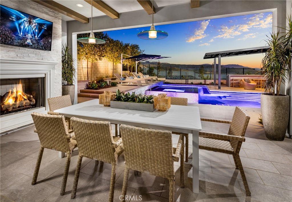 27562 Elderberry Drive Valencia, CA 91381 - Photo 18 of 18 a view of a dining room with furniture a fireplace and chandelier