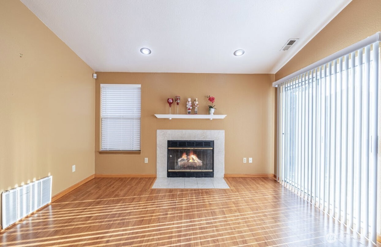 11209 Southeast 267th Place Kent, WA 98030 - Photo 11 of 27 a living room with furniture and a fireplace