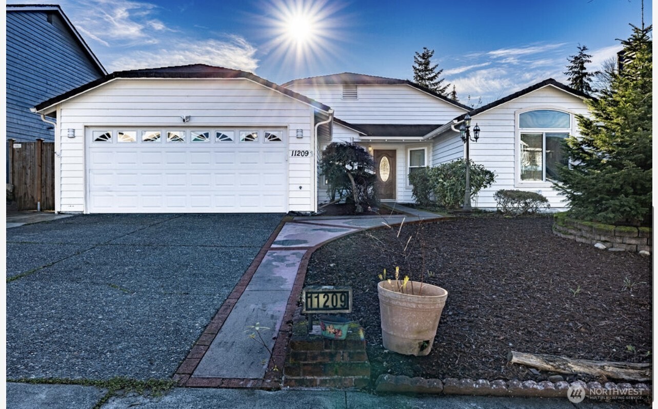 11209 Southeast 267th Place Kent, WA 98030 - Photo 2 of 27 a front view of a house with a yard