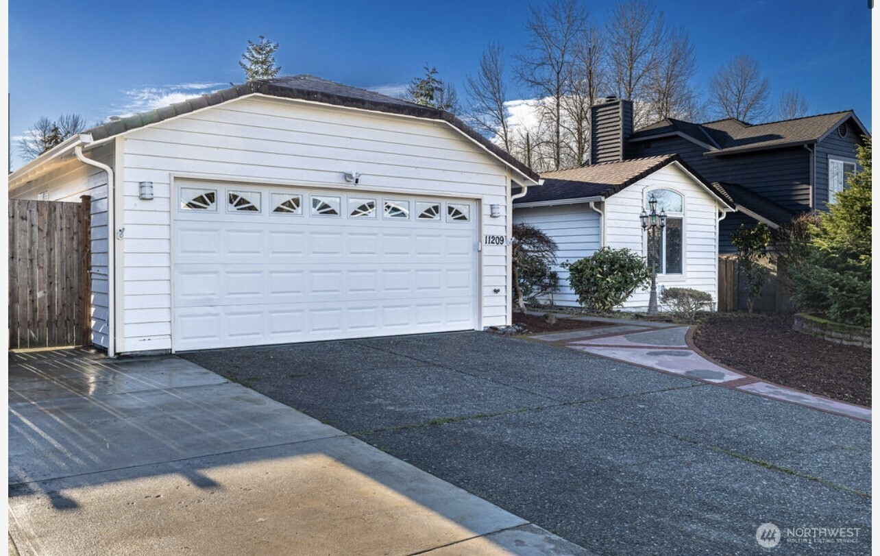 11209 Southeast 267th Place Kent, WA 98030 - Photo 4 of 27 a front view of a house with garage