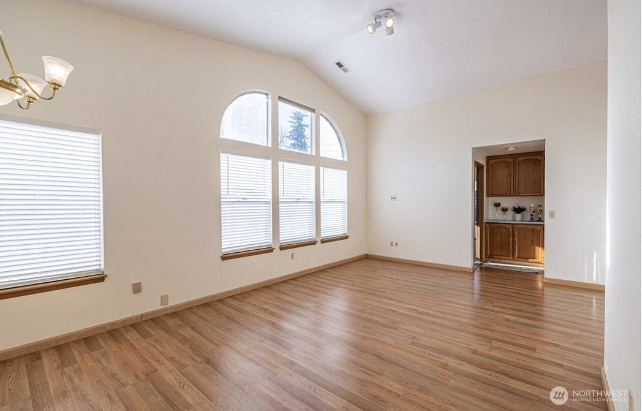 11209 Southeast 267th Place Kent, WA 98030 - Photo 6 of 27 an empty room with wooden floor and windows
