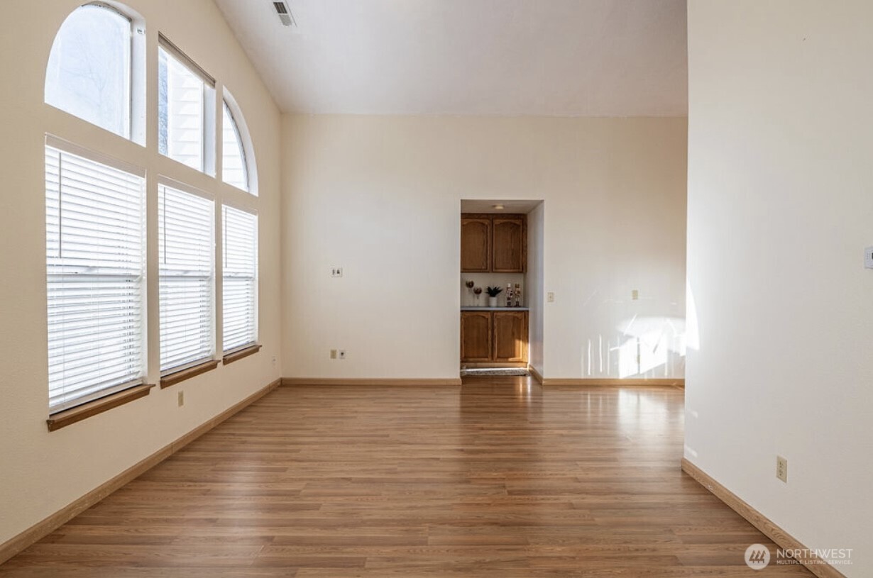 11209 Southeast 267th Place Kent, WA 98030 - Photo 9 of 27 a view of an empty room with window and wooden floor
