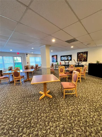 a room with pool table and windows