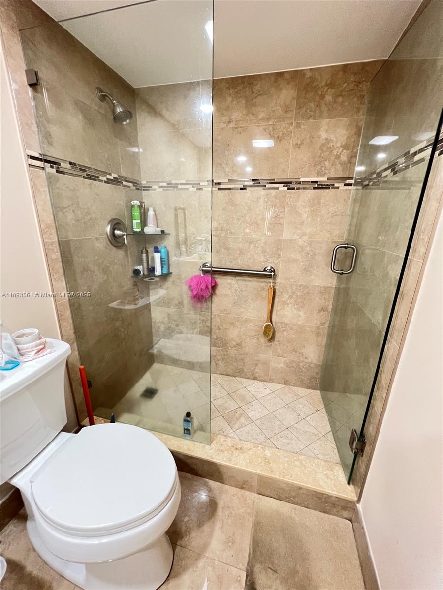 10777 West Sample Road, Unit 301 Coral Springs, FL 33065 - Photo 6 of 12 a bathroom with a toilet and a shower