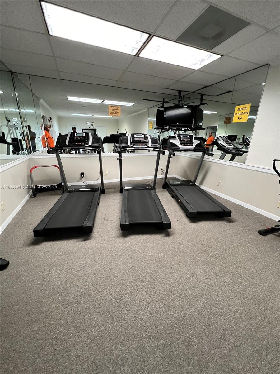 10777 West Sample Road, Unit 301 Coral Springs, FL 33065 - Photo 10 of 12 a view of parking garage with lots of gym equipment