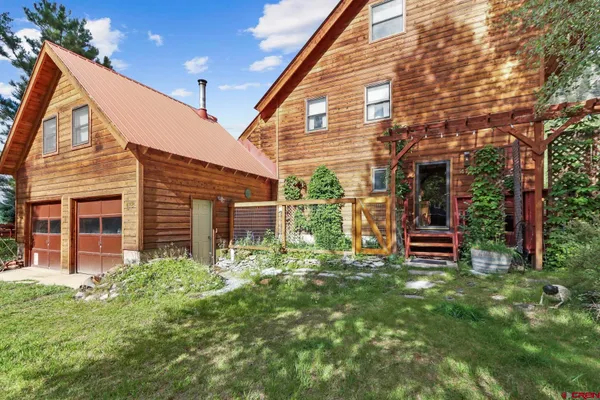 a view of a house with backyard porch and sitting area