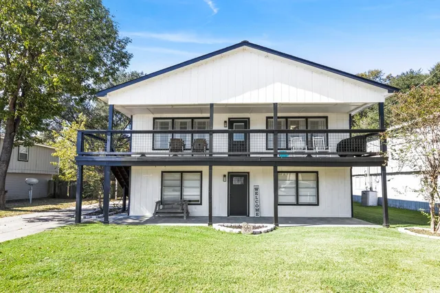 a front view of house with yard and outdoor seating