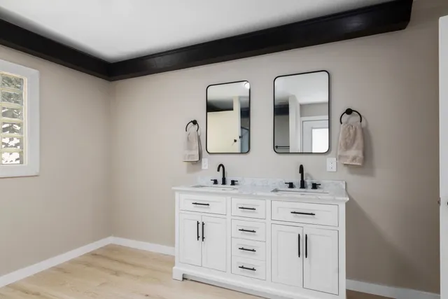 an empty room with a window and a ceiling fan