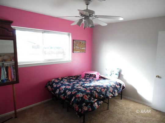 301 East Robertson Road Ridgecrest, CA 93555 - Photo 16 of 30 a bedroom with a bed dresser and a window