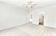 an empty room with fan and entryway