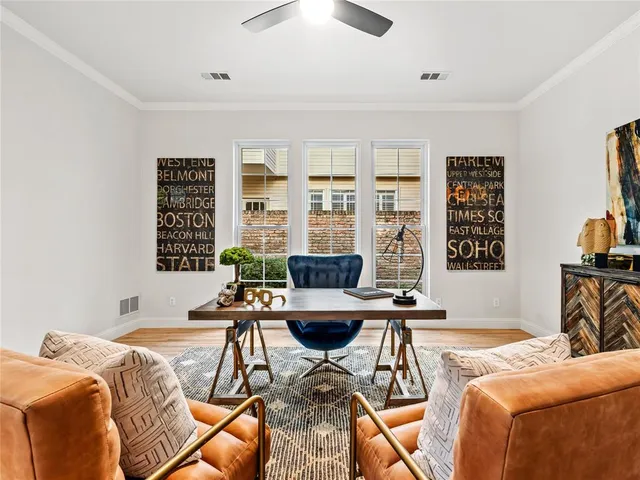 a living room with furniture a fireplace and a large window