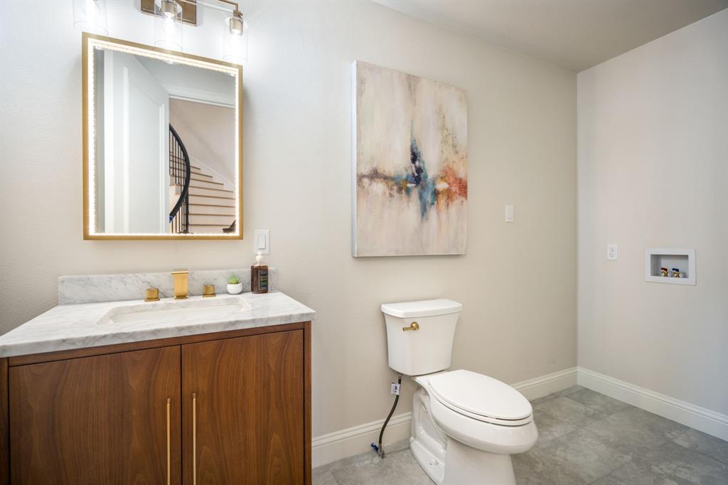 5120 Briar Tree Drive Dallas, TX 75248 - Photo 16 of 40 a bathroom with a toilet sink and mirror