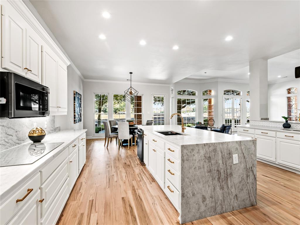 5120 Briar Tree Drive Dallas, TX 75248 - Photo 18 of 40 a kitchen with stainless steel appliances kitchen island granite countertop a stove and a sink