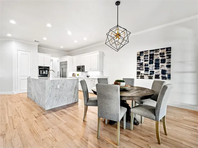 a view of a dining room with furniture wooden floor and a chandelier