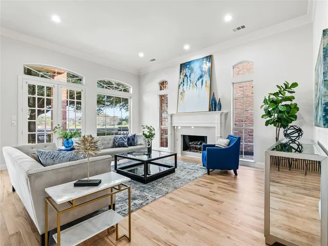a living room with furniture a fireplace and a potted plant