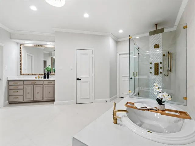 a bathroom with a tub sink and mirror
