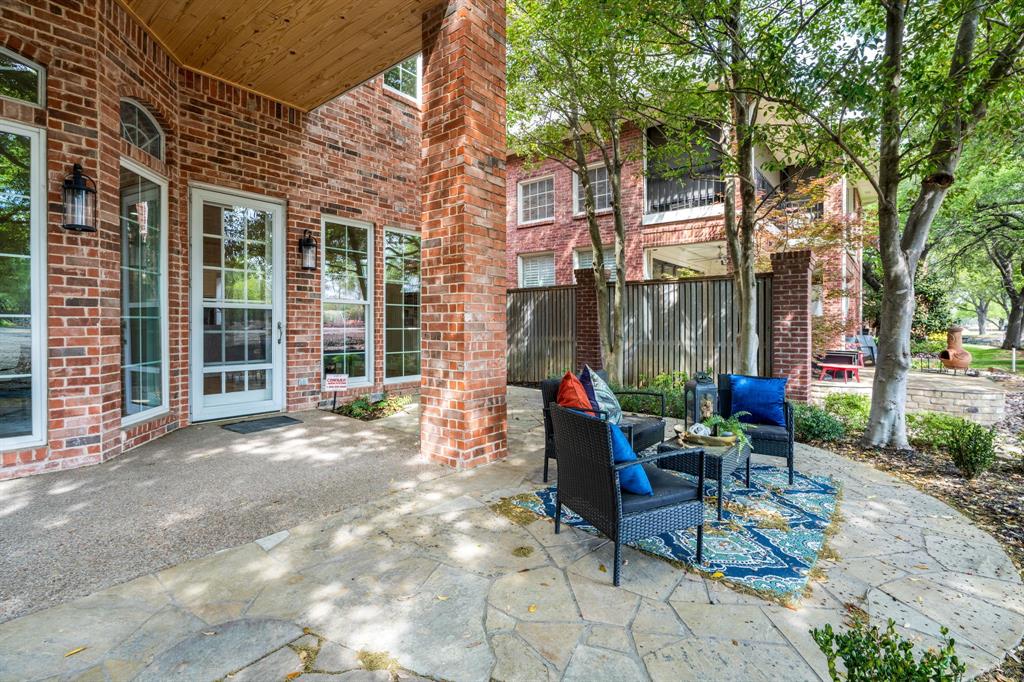 5120 Briar Tree Drive Dallas, TX 75248 - Photo 34 of 40 a view of a patio with table and chairs and floor to ceiling window