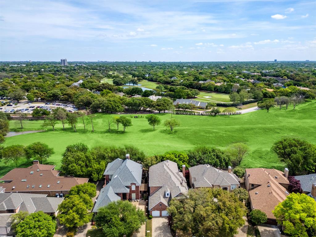 5120 Briar Tree Drive Dallas, TX 75248 - Photo 36 of 40 a view of a garden with a building in the background