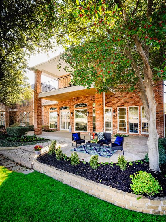 5120 Briar Tree Drive Dallas, TX 75248 - Photo 39 of 40 a front view of a house with a yard table and chairs