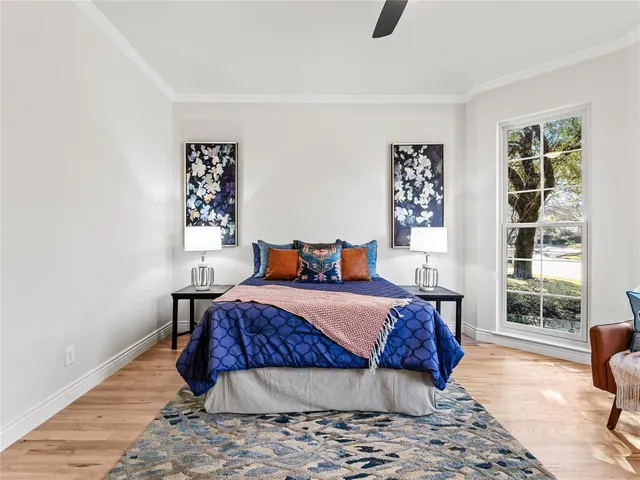 a bedroom with a large bed and a window