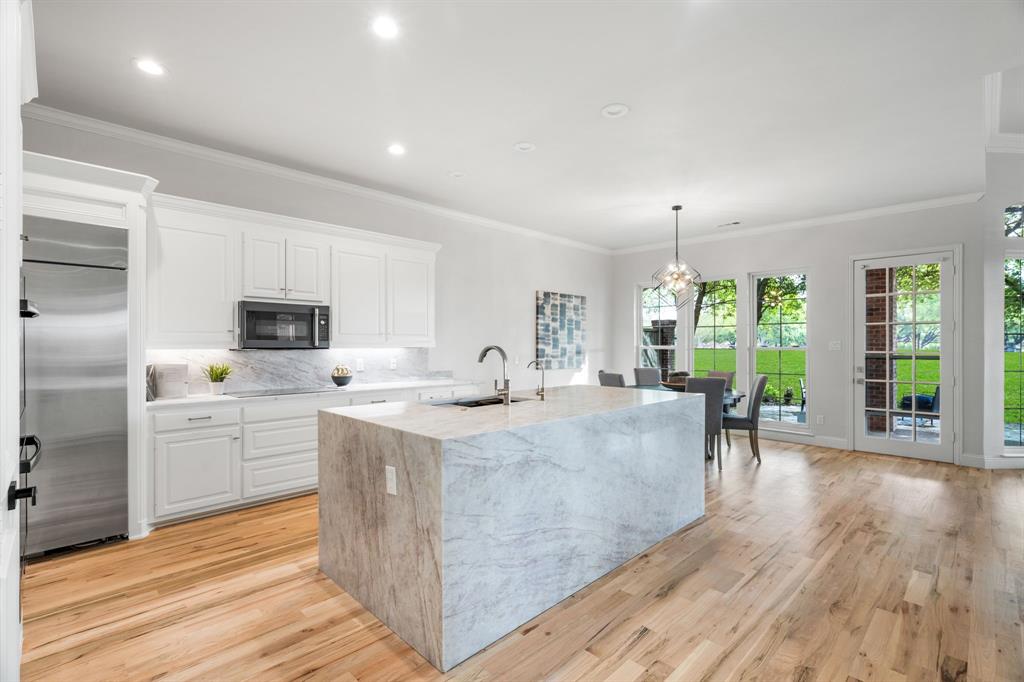 5120 Briar Tree Drive Dallas, TX 75248 - Photo 6 of 40 a large white kitchen with cabinets stove and refrigerator