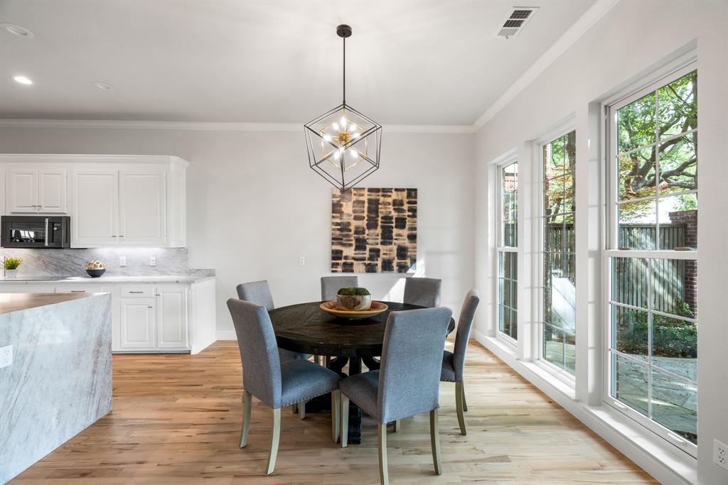 5120 Briar Tree Drive Dallas, TX 75248 - Photo 7 of 40 a dining room with wooden floor a chandelier a wooden table and chairs