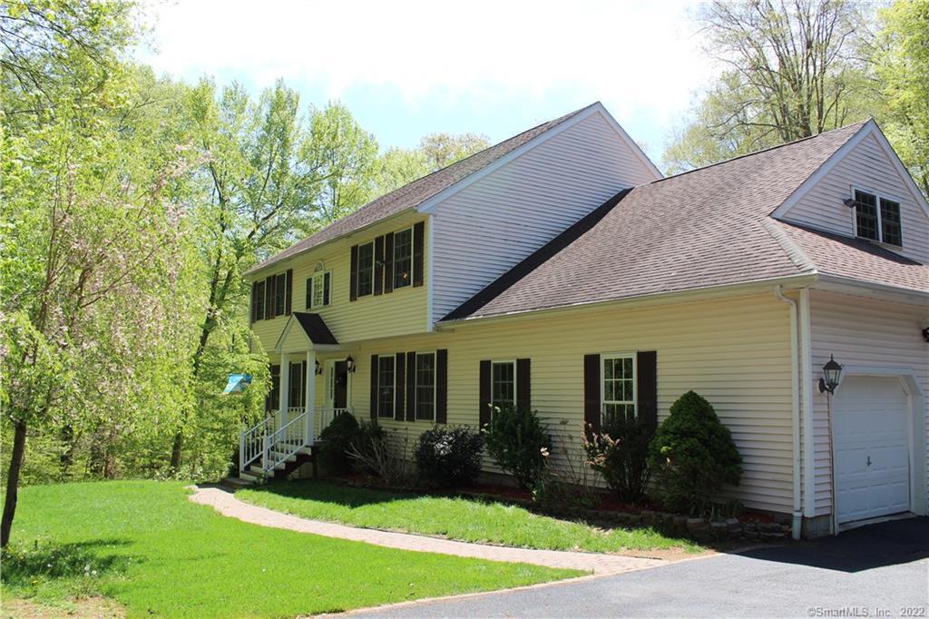 322 Hollow Road Orange, CT 06477 - Photo 1 of 1 a view of a white house with a yard plants and large tree