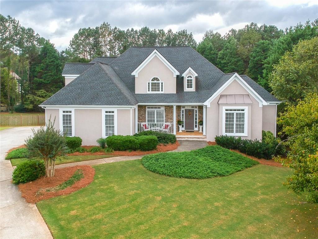 575 Trotters Ridge Roswell, GA 30075 - Photo 1 of 1 Elegant, hard coat stucco, beautiful stone accents and full southern front porch over looks the quiet cul-de-sac.
