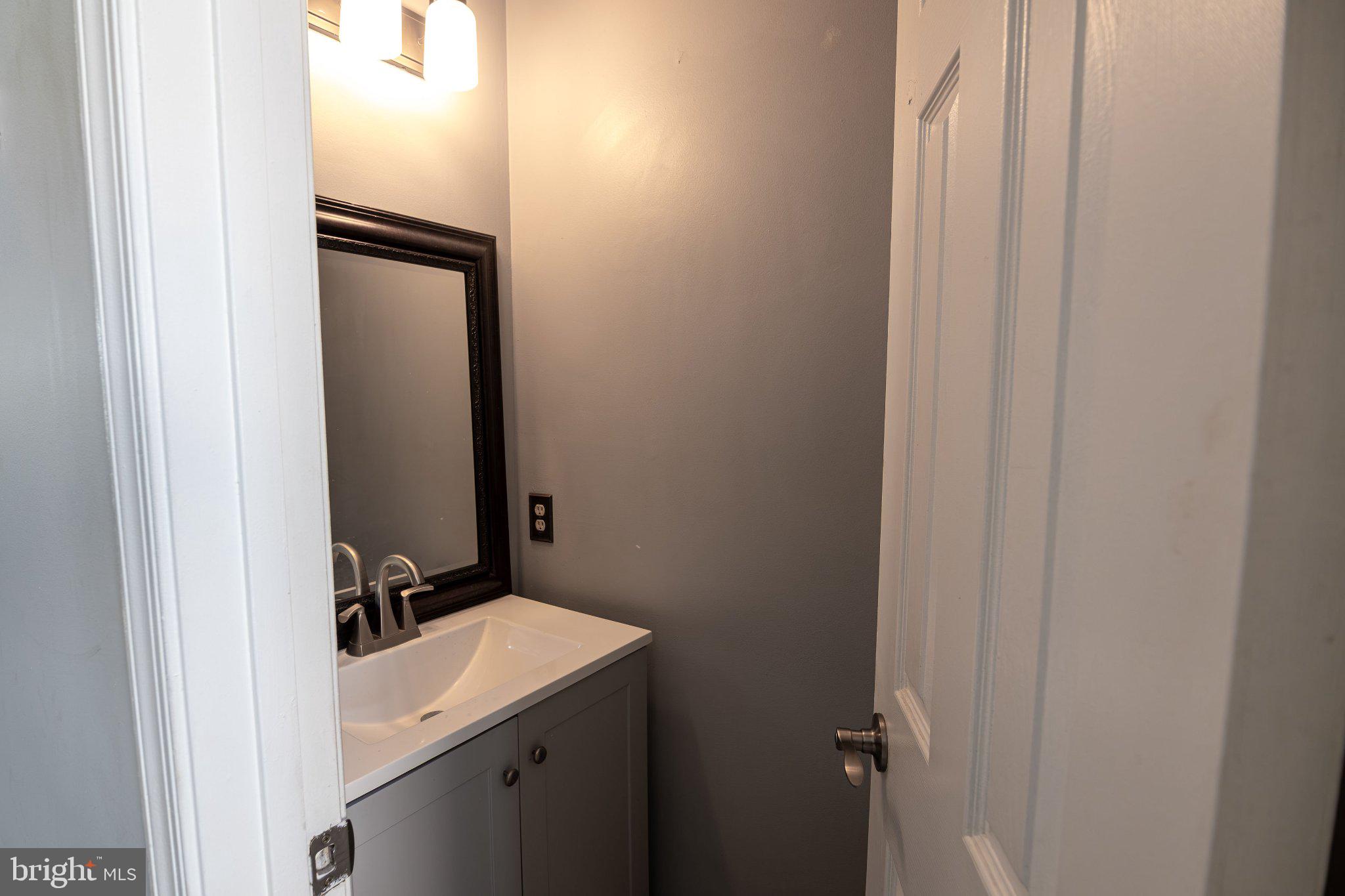 308 Raft Cove Stafford, VA 22554 - Photo 3 of 28 a bathroom with a sink and a mirror